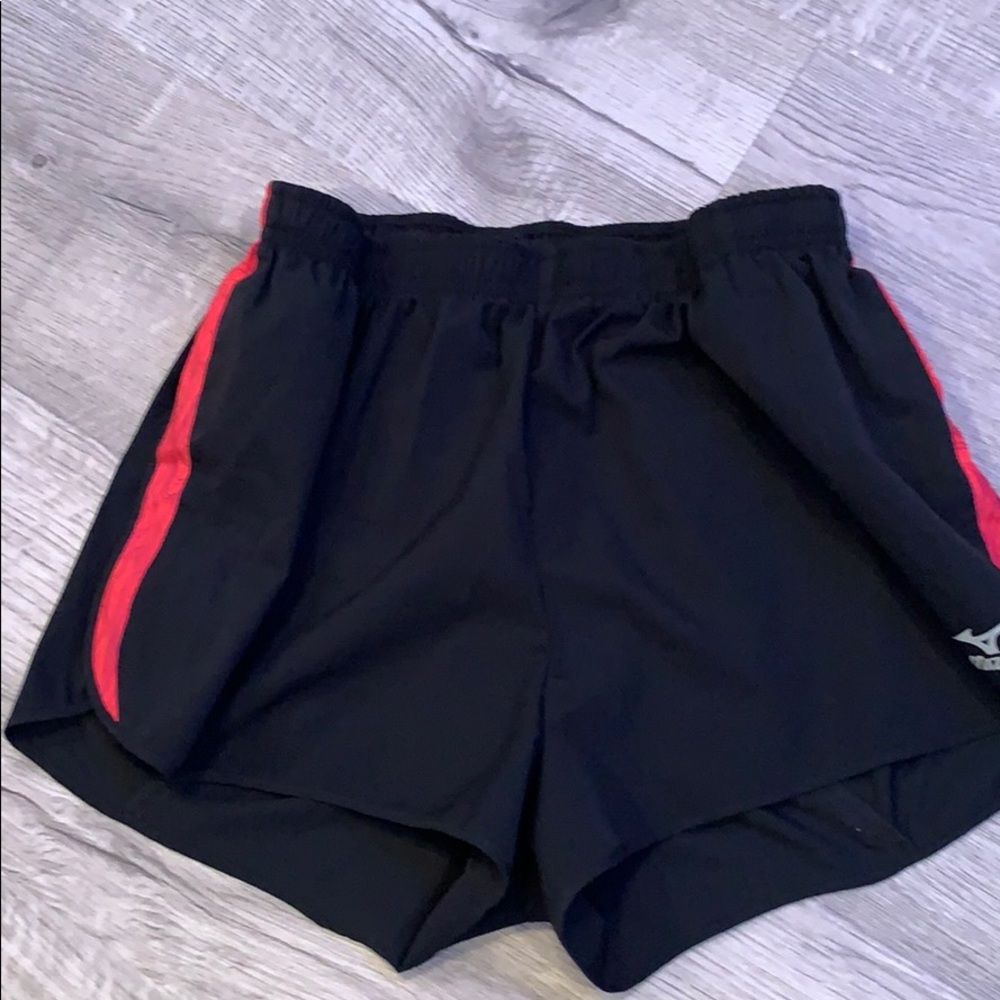 Black athletic shorts with pink strip